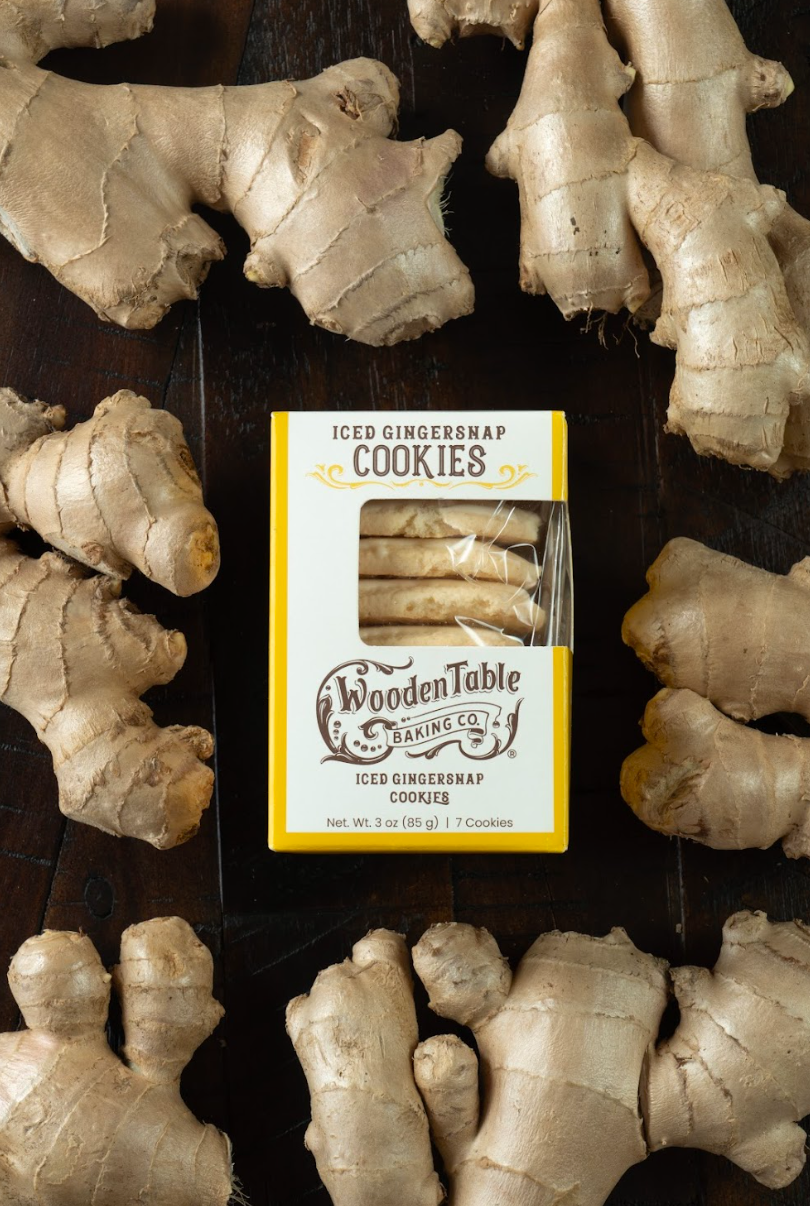  Gingersnap Meringue Tea Cookies In A Package And Surrounded By Fresh Ginger Root