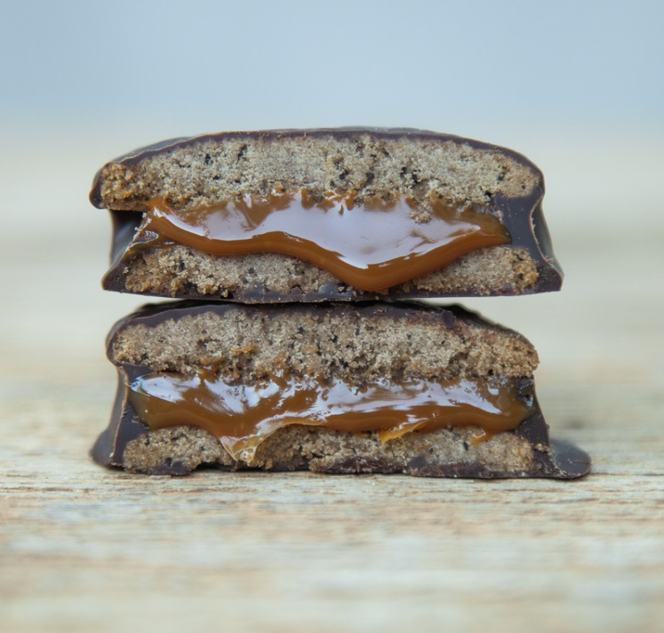 Dark chocolate alfajor cut in half